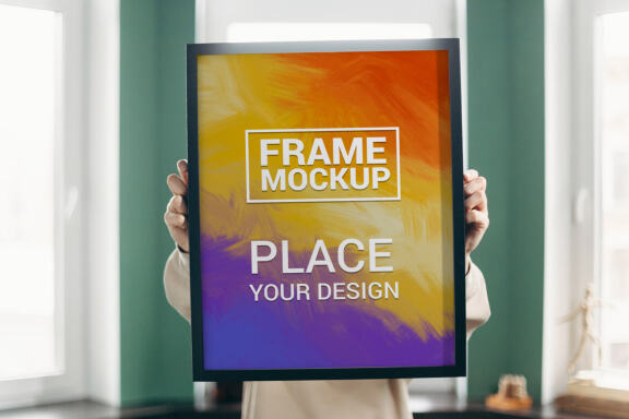 Girl Holding a Black Frame Poster - Free Mockup #1